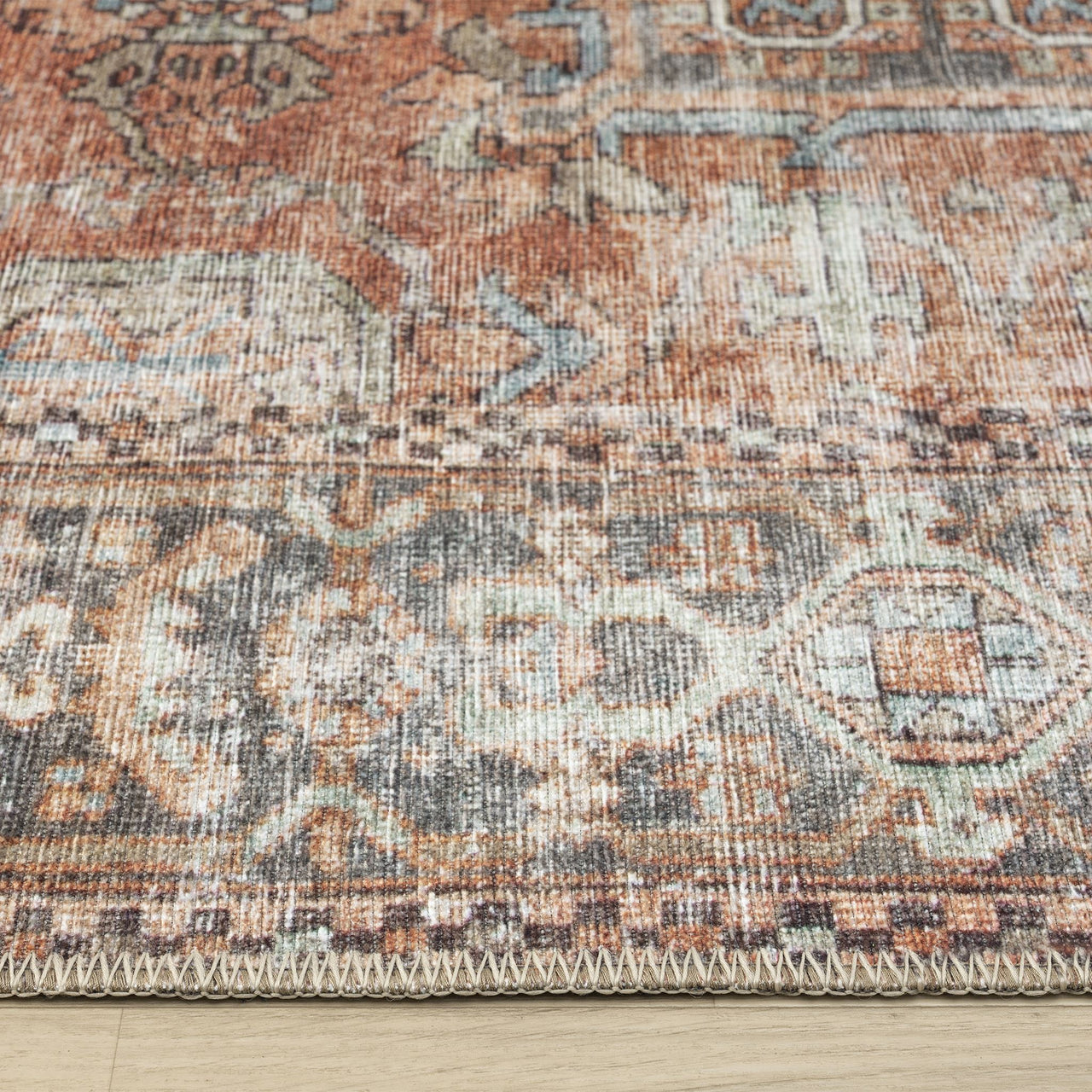 Rust and beige floral patterned flatweave runner rug with distressed vintage traditional design.