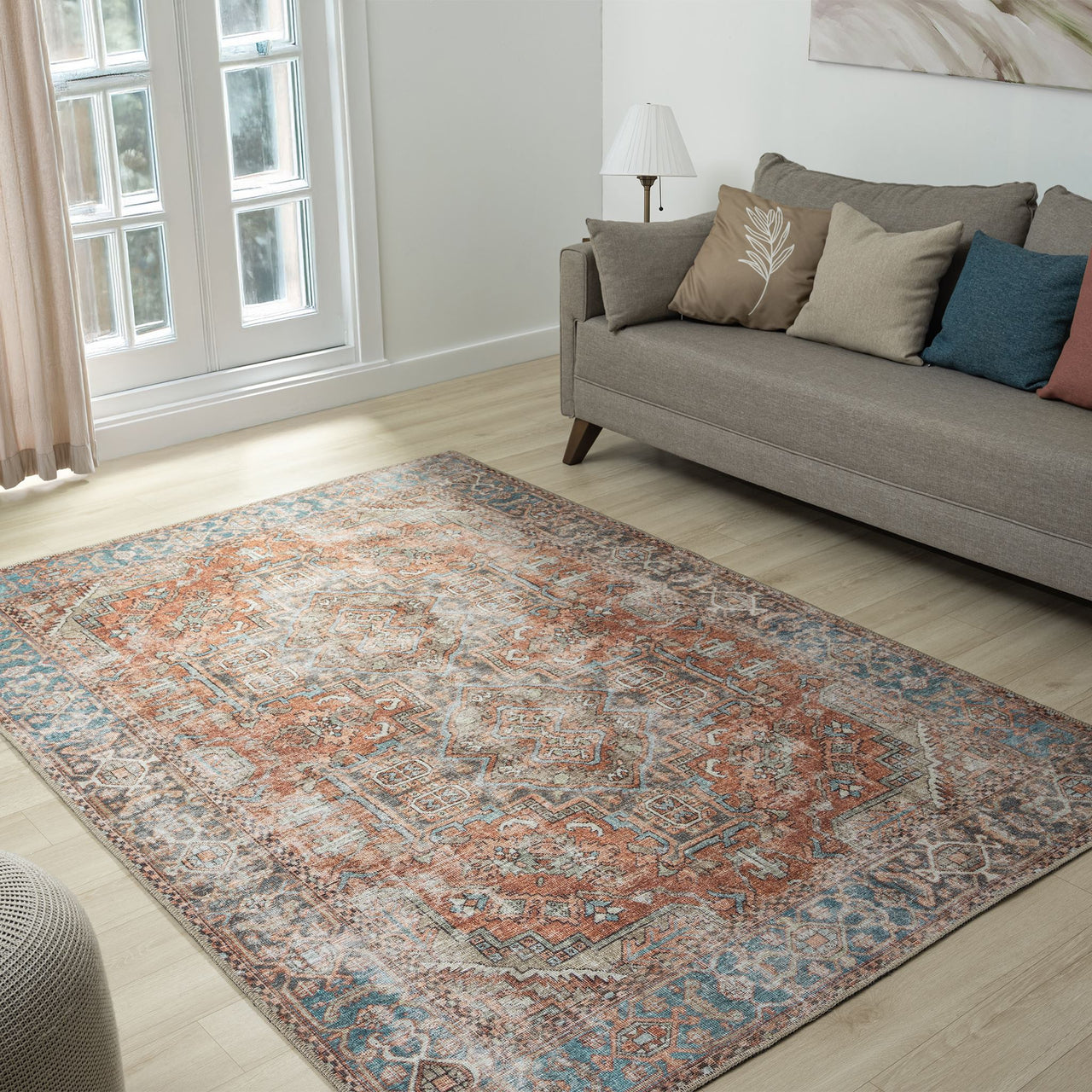 Multi-colored traditional floral rug with distressed vintage design and muted earthy tones.