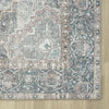 Grey traditional runner rug corner with intricate floral and geometric patterns in muted blue, beige, and rust tones,.
