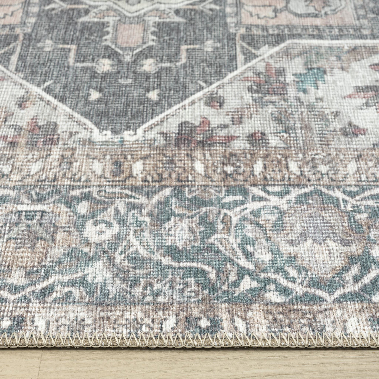 Grey multi-colored runner rug with intricate traditional floral patterns and distressed flatweave texture.