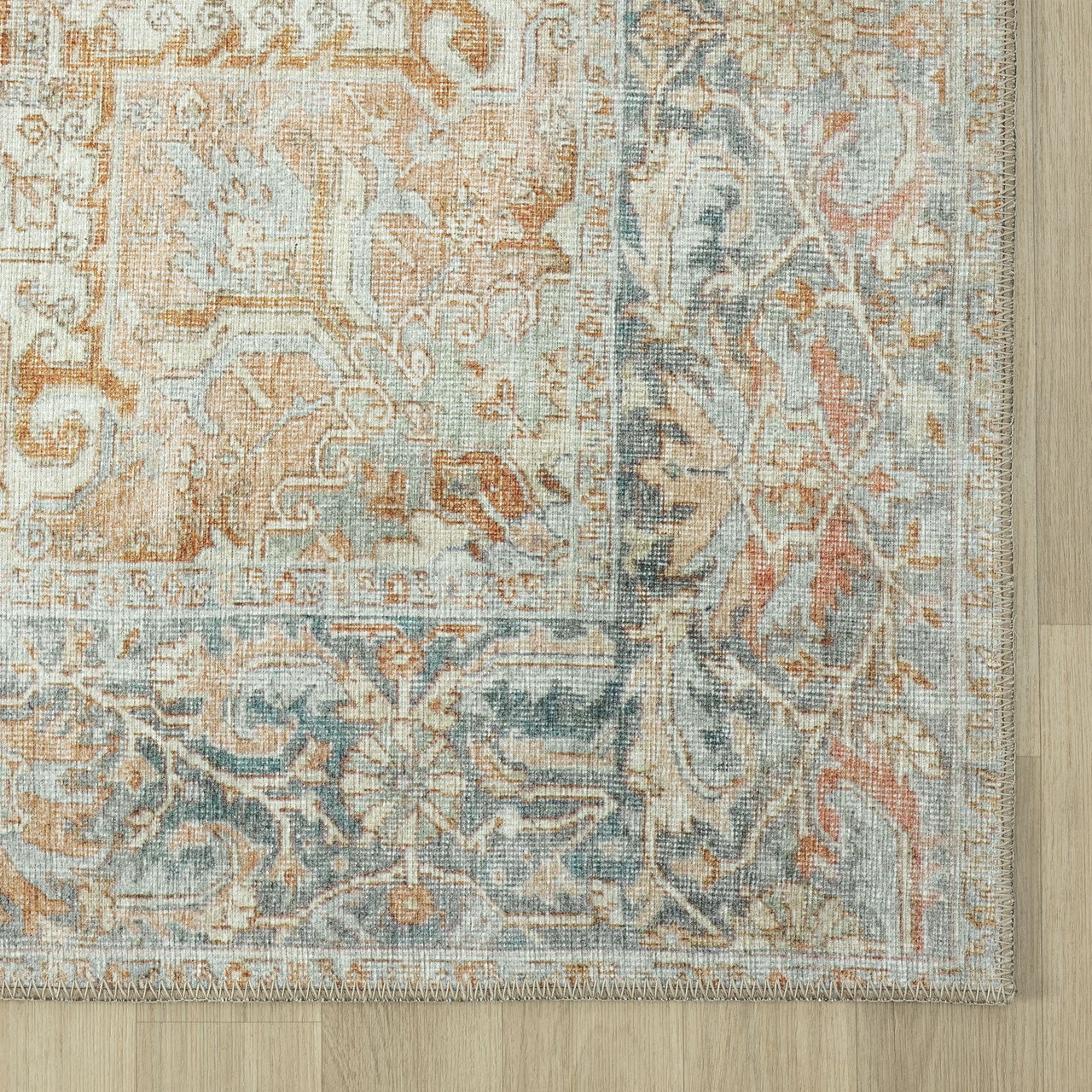 Traditional multi-colored runner rug with distressed floral motifs in soft beige, blue, and rust tones.