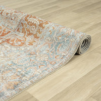 Multi-coloured traditional runner rug with floral and geometric patterns in muted orange, blue, and beige tones, flatwoven.