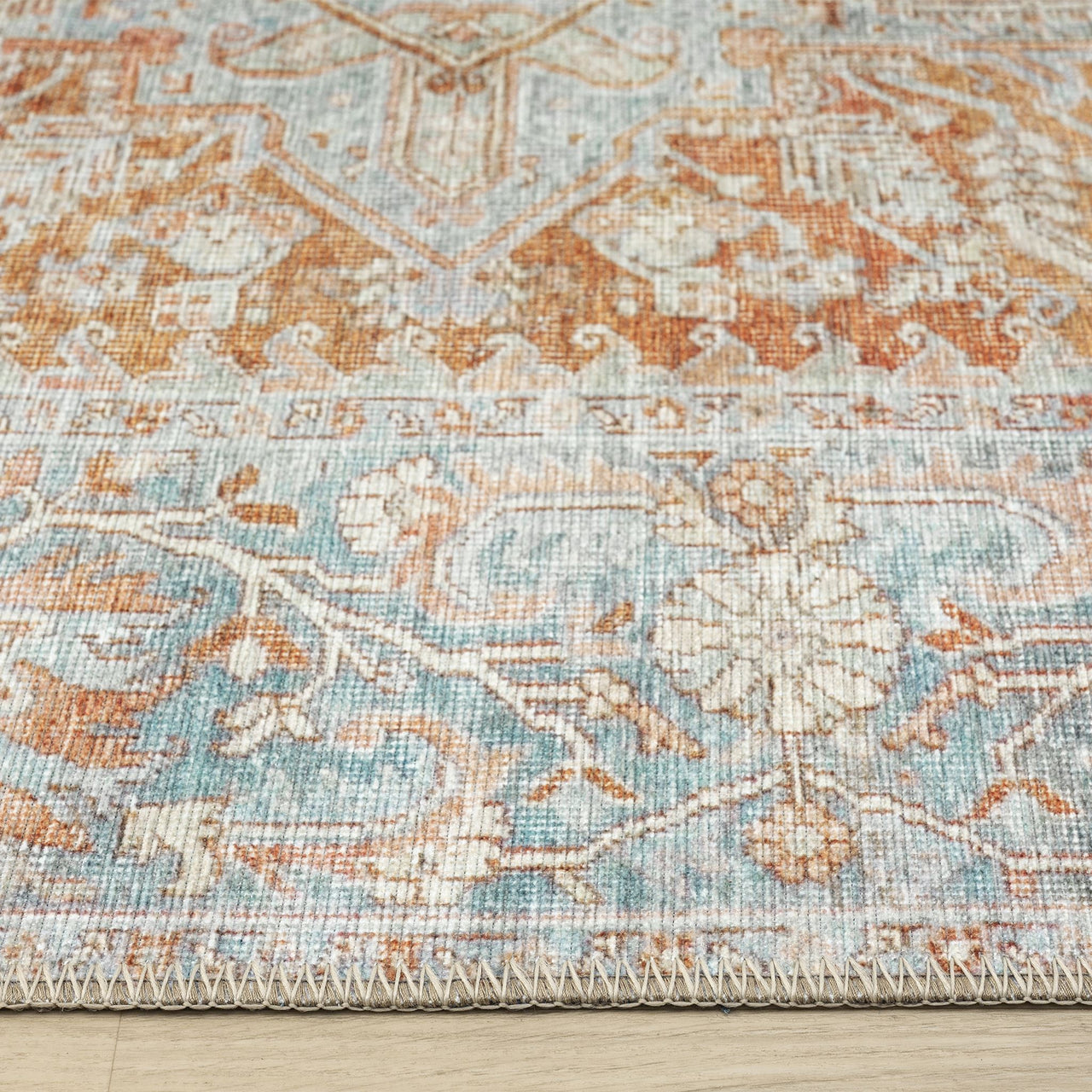 Flatweave traditional runner rug with intricate floral and geometric patterns in muted blue, beige, and rust tones.