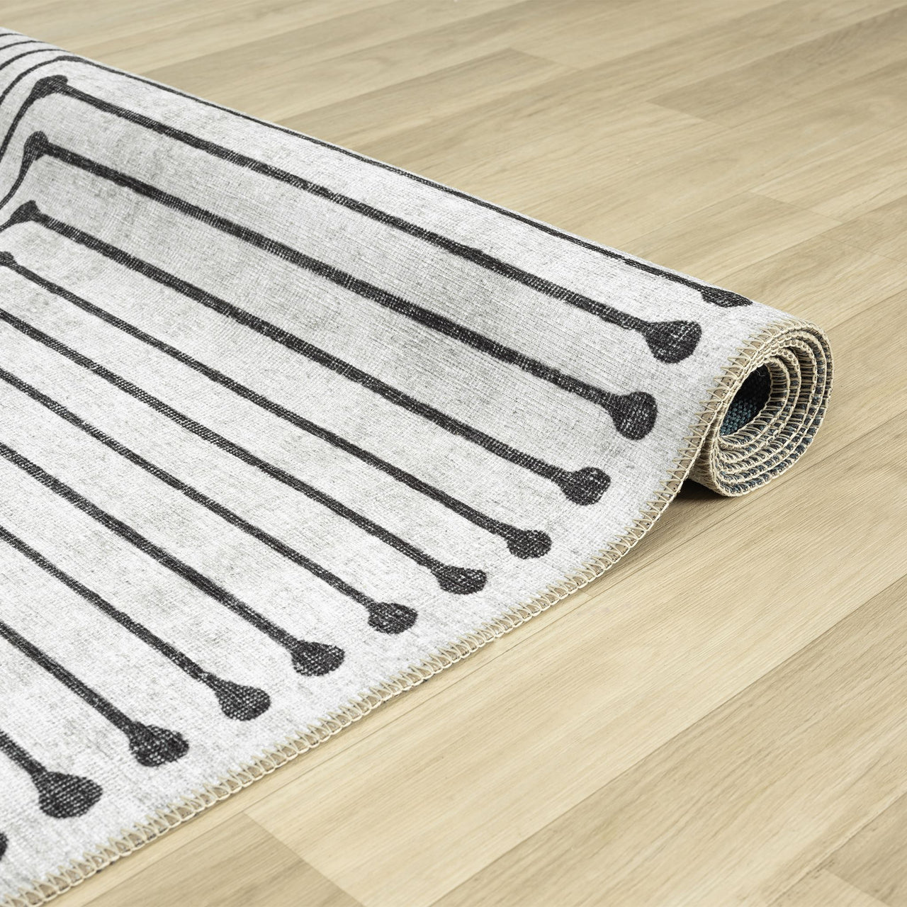 Black and white geometric patterned flatweave traditional runner rug with linear motifs on light background.