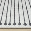 Black and white geometric patterned runner rug with vertical lines and rounded ends on flat-weave texture.