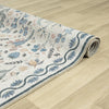 Traditional runner rug with multi-coloured floral and tree motifs on a cream background, bordered with blue wave and leaf.