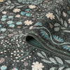 Grey runner rug with intricate multicoloured floral patterns in blue, cream, and green tones, flatweave texture.