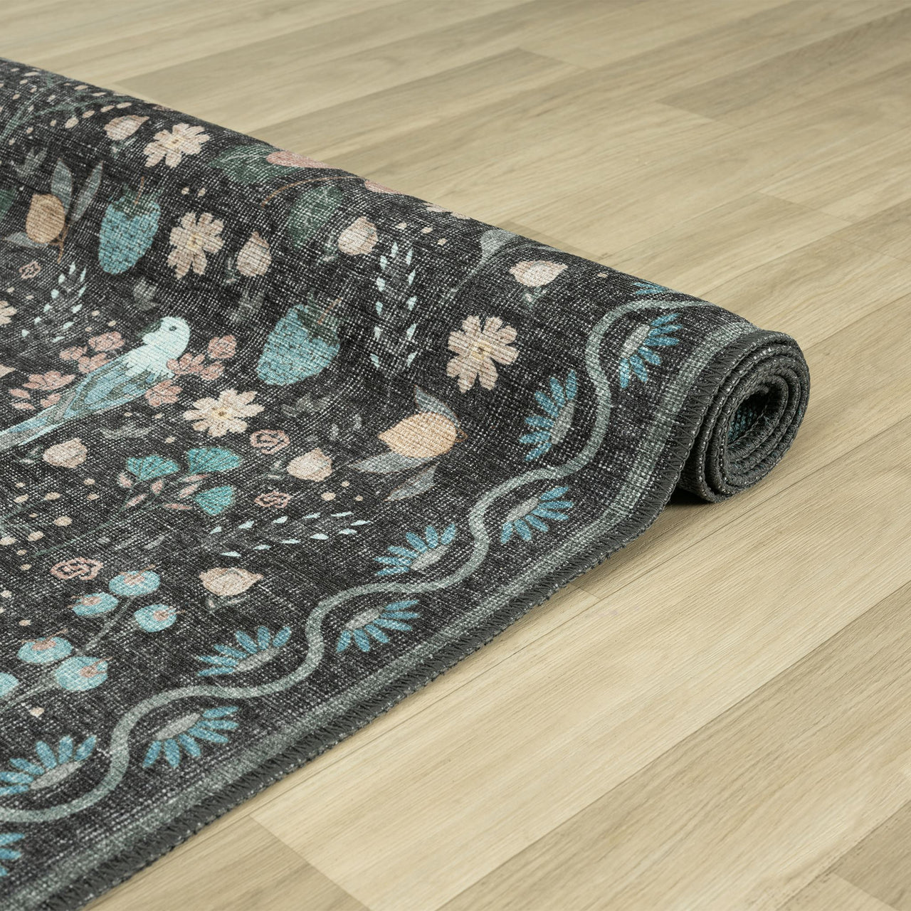 Grey traditional runner rug with distressed multi-colored floral patterns and ornate border design.