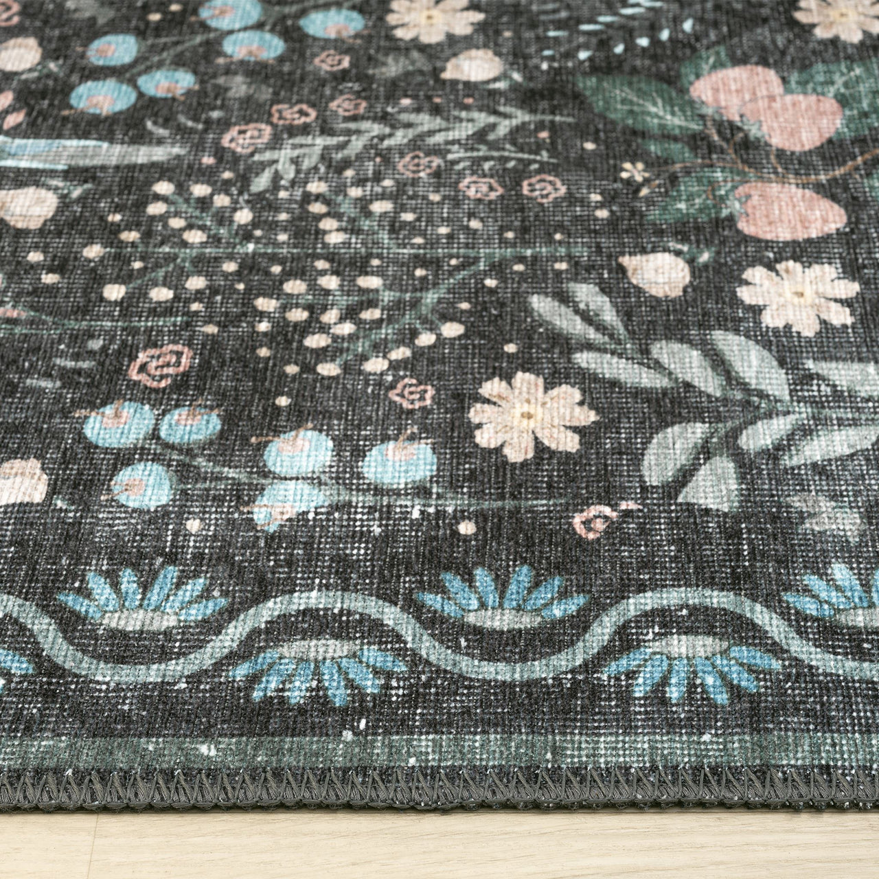 Grey traditional flatweave runner rug with delicate multicolored floral and leafy motifs.