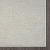 Beige flatweave runner rug with subtle geometric texture and clean edges on hardwood floor.