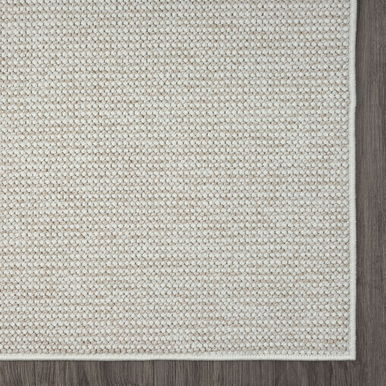 Beige flatweave runner rug with subtle geometric texture and clean edges on hardwood floor.
