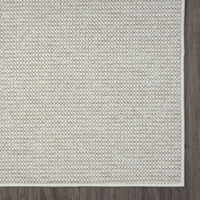 Beige flatweave runner rug with subtle geometric texture and clean edges on hardwood floor.
