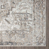 Transitional rug corner with intricate geometric and floral patterns in earth tones of beige, brown, and grey.