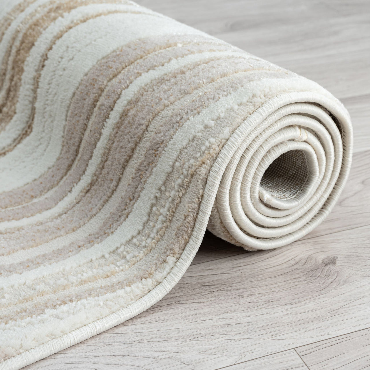 Rolled-up textured rug on a wooden floor