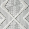 White rug with textured geometric diamond pattern and subtle gray woven background.