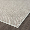 Beige flatweave runner rug with subtle textured geometric pattern and clean edges on dark wood floor.