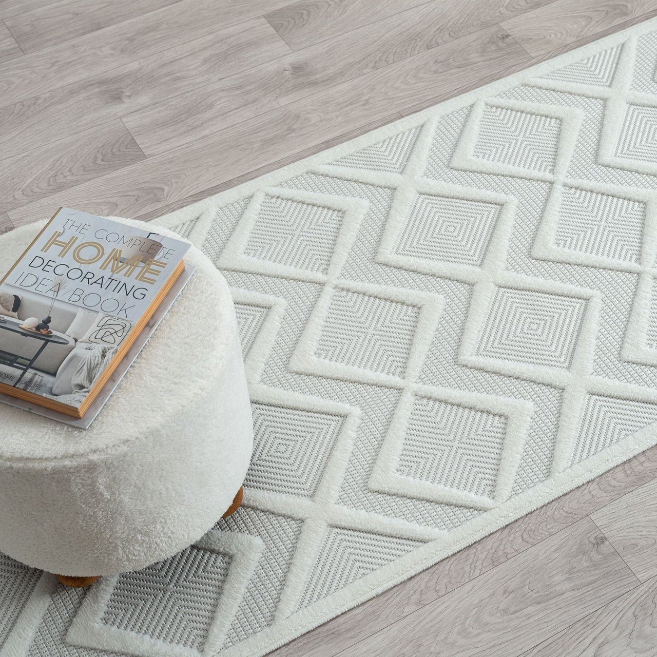 White runner rug with textured geometric diamond pattern on light neutral background.