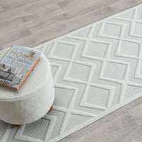 White runner rug with textured geometric diamond pattern on light neutral background.