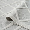 White rug with raised geometric diamond patterns and textured polypropylene pile.