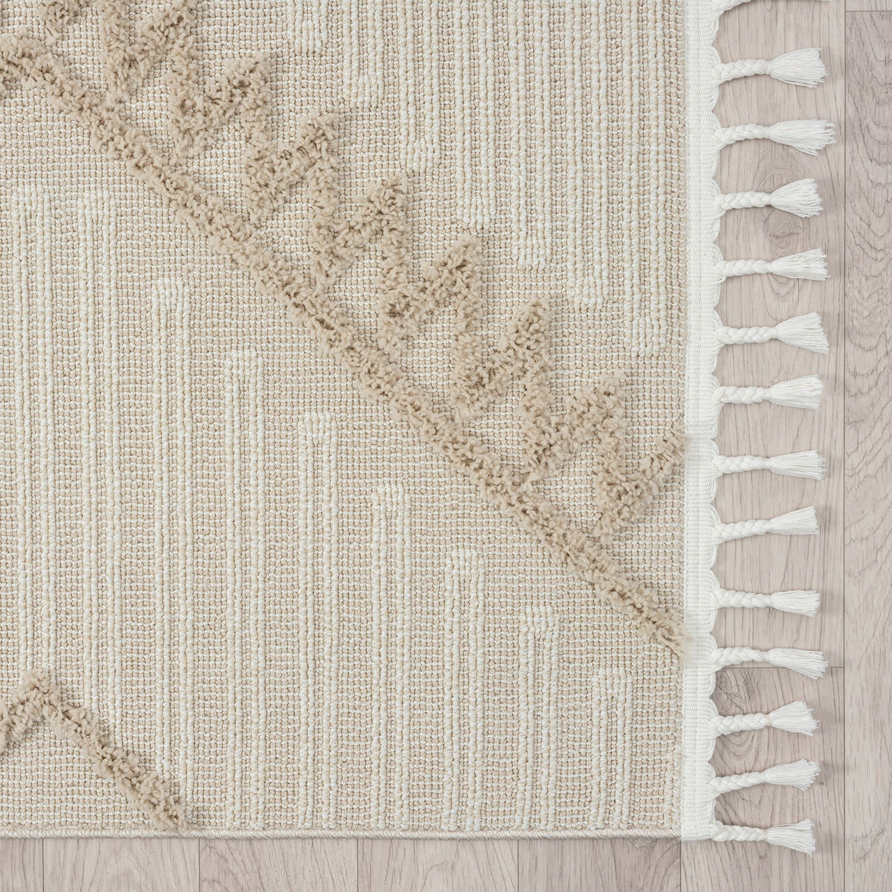 Taupe and beige runner rug with modern geometric pattern and white fringed edges.