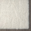 Cream-colored modern shaggy runner rug with dense, soft polyester fibers and a plush texture.