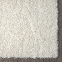 Cream-colored modern shaggy runner rug with dense, soft polyester fibers and a plush texture.