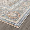 Soft coral and gray patterned runner rug with distressed modern design on wooden floor.