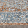 Modern indigo runner rug with intricate geometric and floral patterns in blue and rust tones on a textured surface.