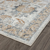 Close-up of a muted multi-colored runner rug with soft blue, beige, and rust tones and intricate traditional patterns on a.