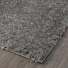 Grey and silver modern shaggy runner rug with plush polyester fibers on wood floor.