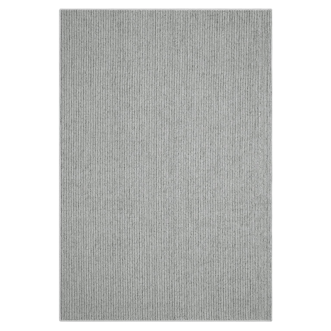 Grey flatweave rug with subtle textured geometric pattern and minimalist modern design.