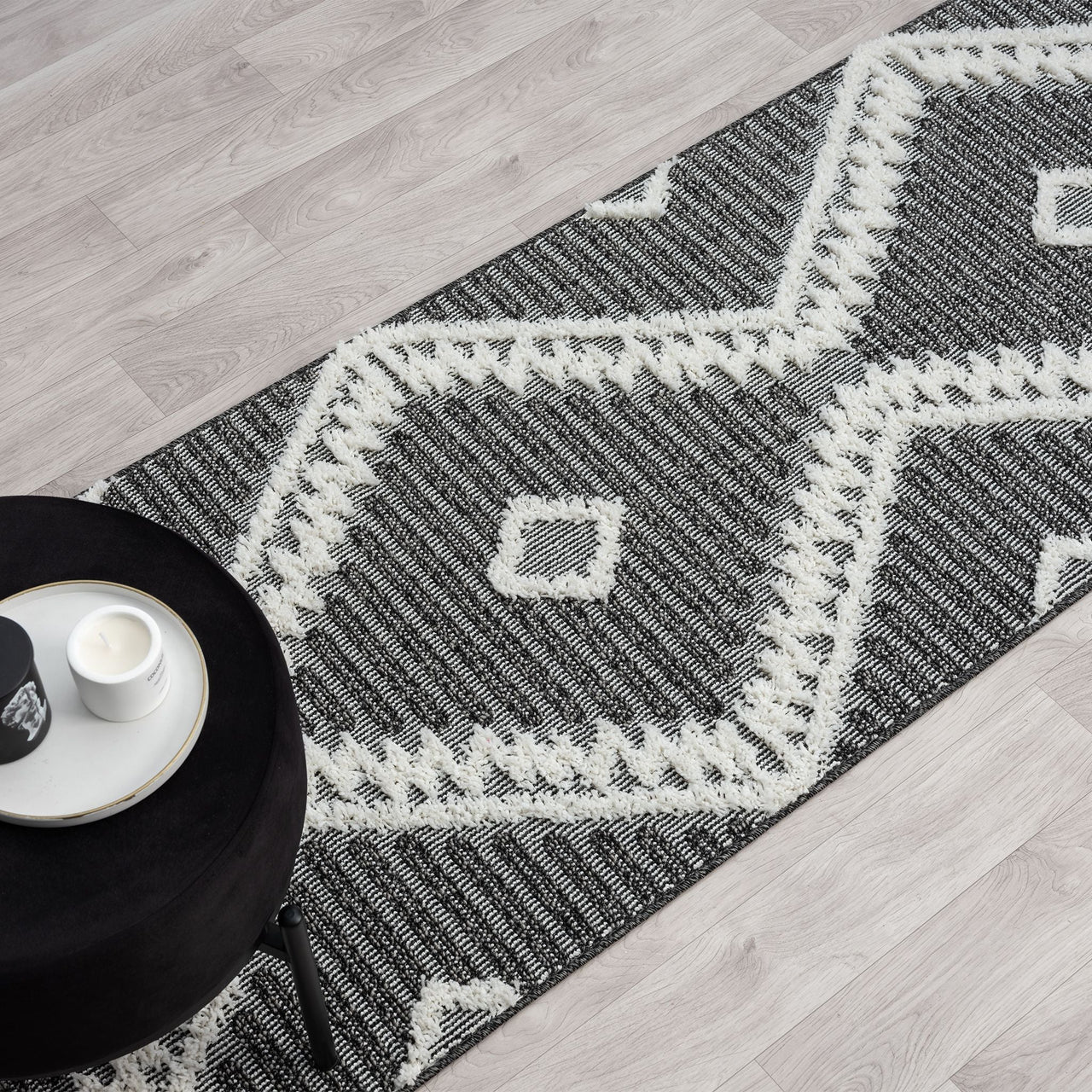 Grey and white modern geometric patterned runner rug with textured pile and fringed edges.