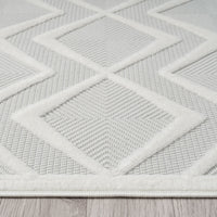 White runner rug with raised geometric diamond pattern and textured polypropylene pile.