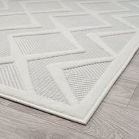 White modern runner rug with raised geometric square and triangle patterns on textured pile.