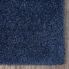 Close-up of plush navy blue shaggy runner rug with dense, textured polyester fibers.