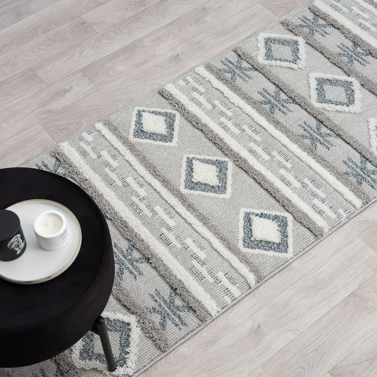 Grey and beige runner rug with modern geometric diamond and stripe pattern, fringed edges.