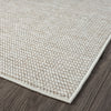 Beige flatweave rug with a subtle textured geometric pattern and clean edge on dark hardwood floor.