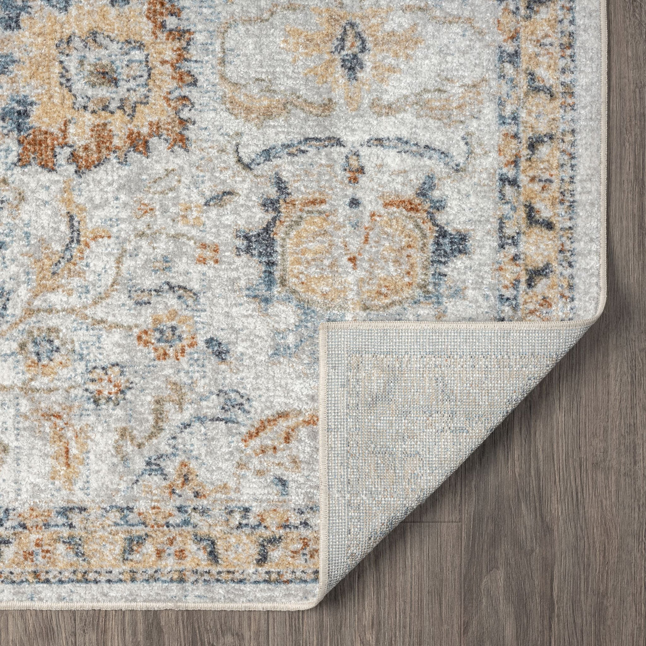 Multi-color modern pearl runner rug with intricate pattern and beige border, corner folded on wooden floor.