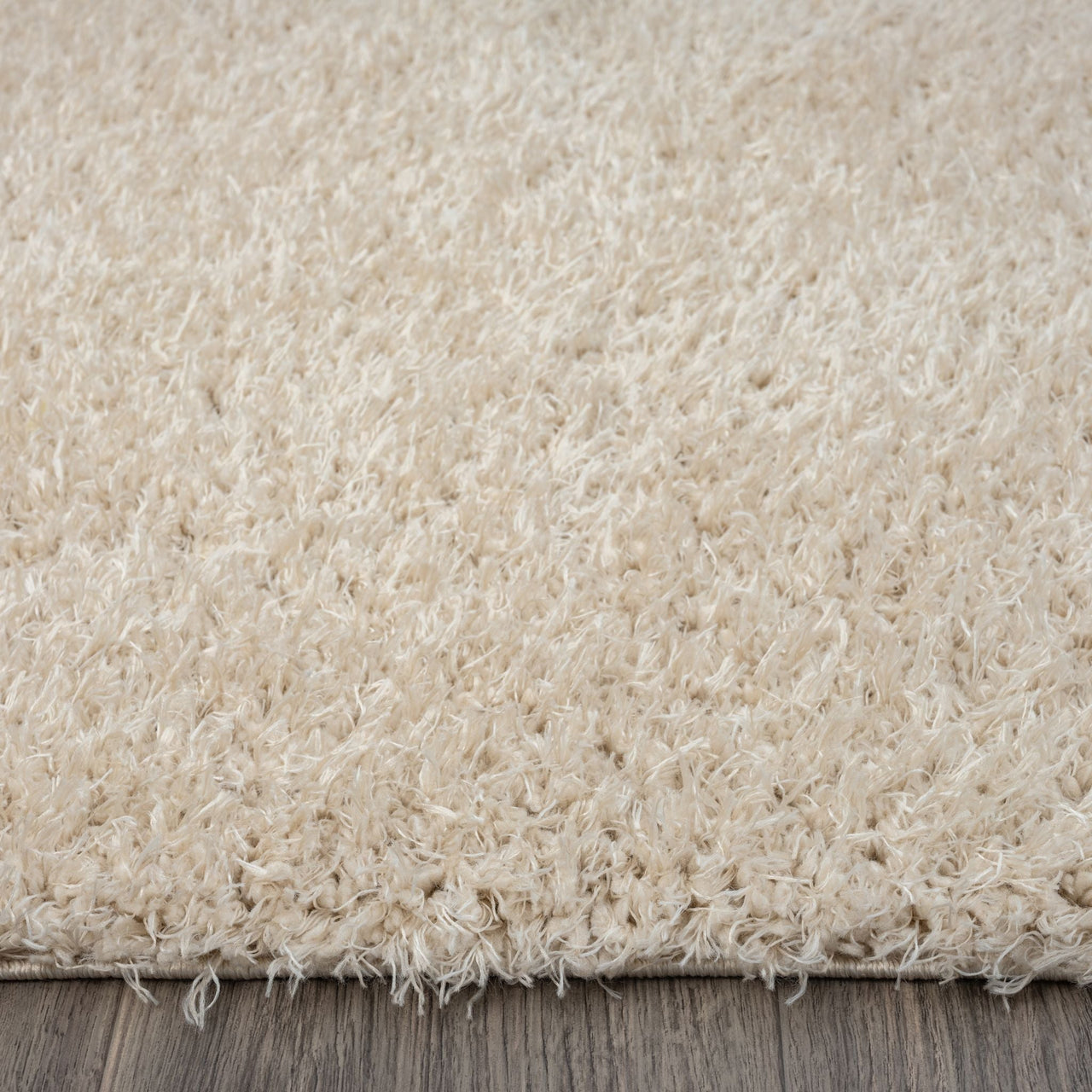 Beige modern shaggy runner rug with soft, dense polyester fibers on a hardwood floor.