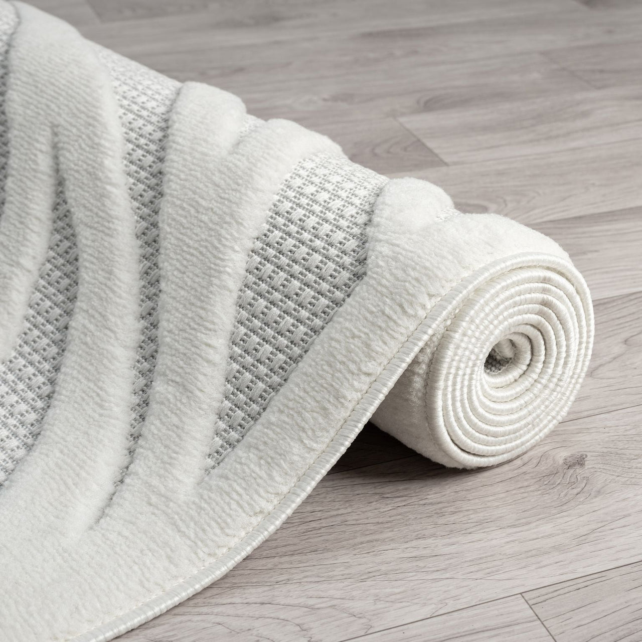 Ivory runner rug with textured geometric pattern and soft polypropylene pile on light wood floor.