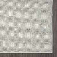 Beige flatweave rug with subtle geometric pattern and a clean stitched edge.