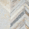 Multi-colored geometric patterned runner rug in beige, gray, and gold tones with abstract texture.