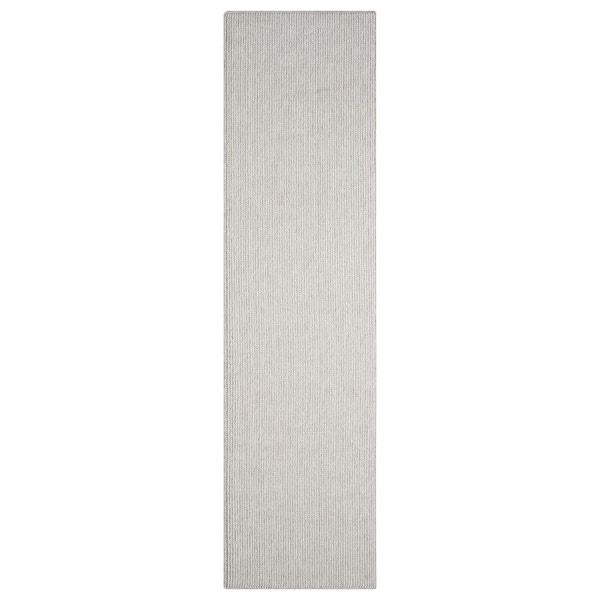Beige flatweave runner rug with subtle textured pattern and minimalist modern design.