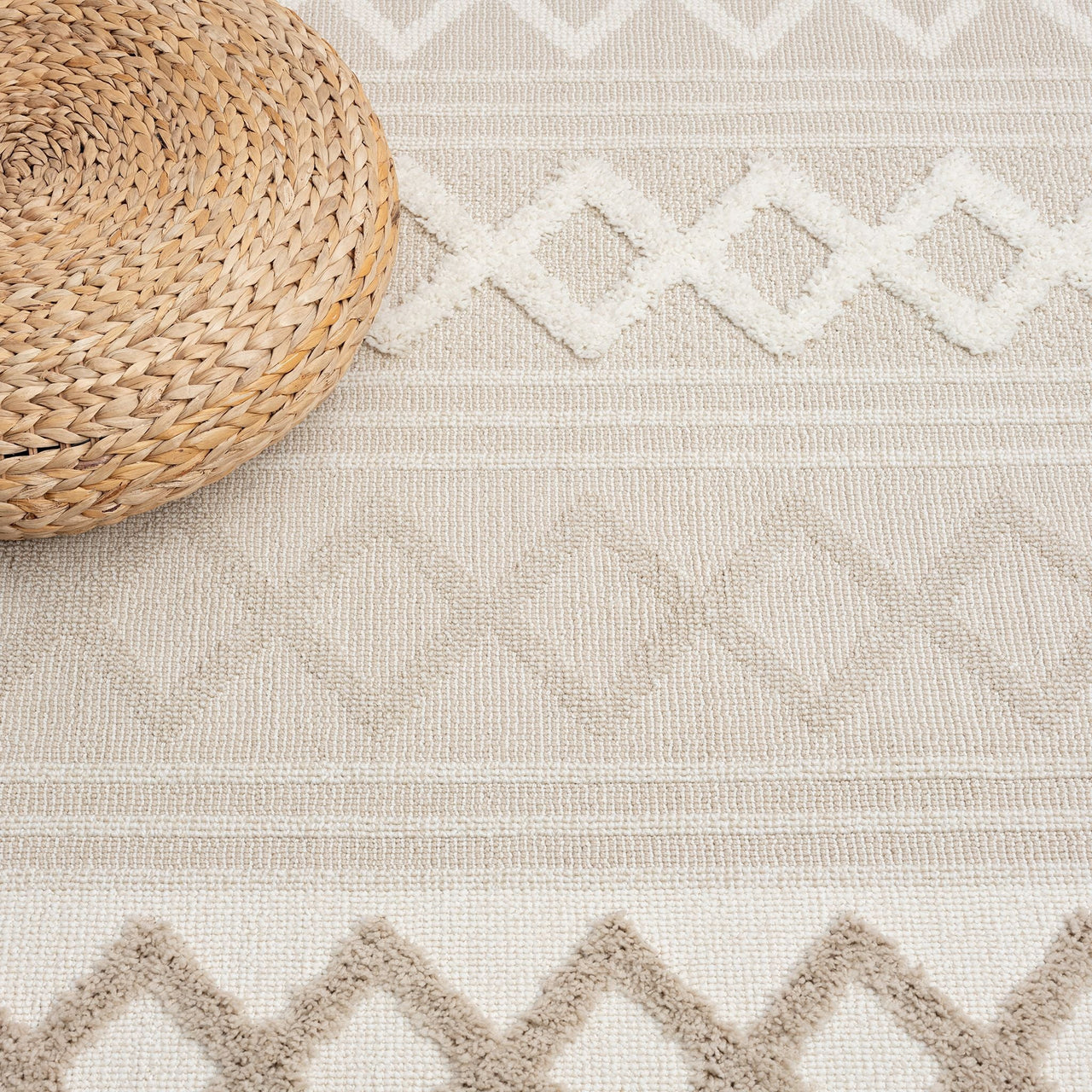 Beige and cream round rug with textured geometric diamond patterns and fringed edges.