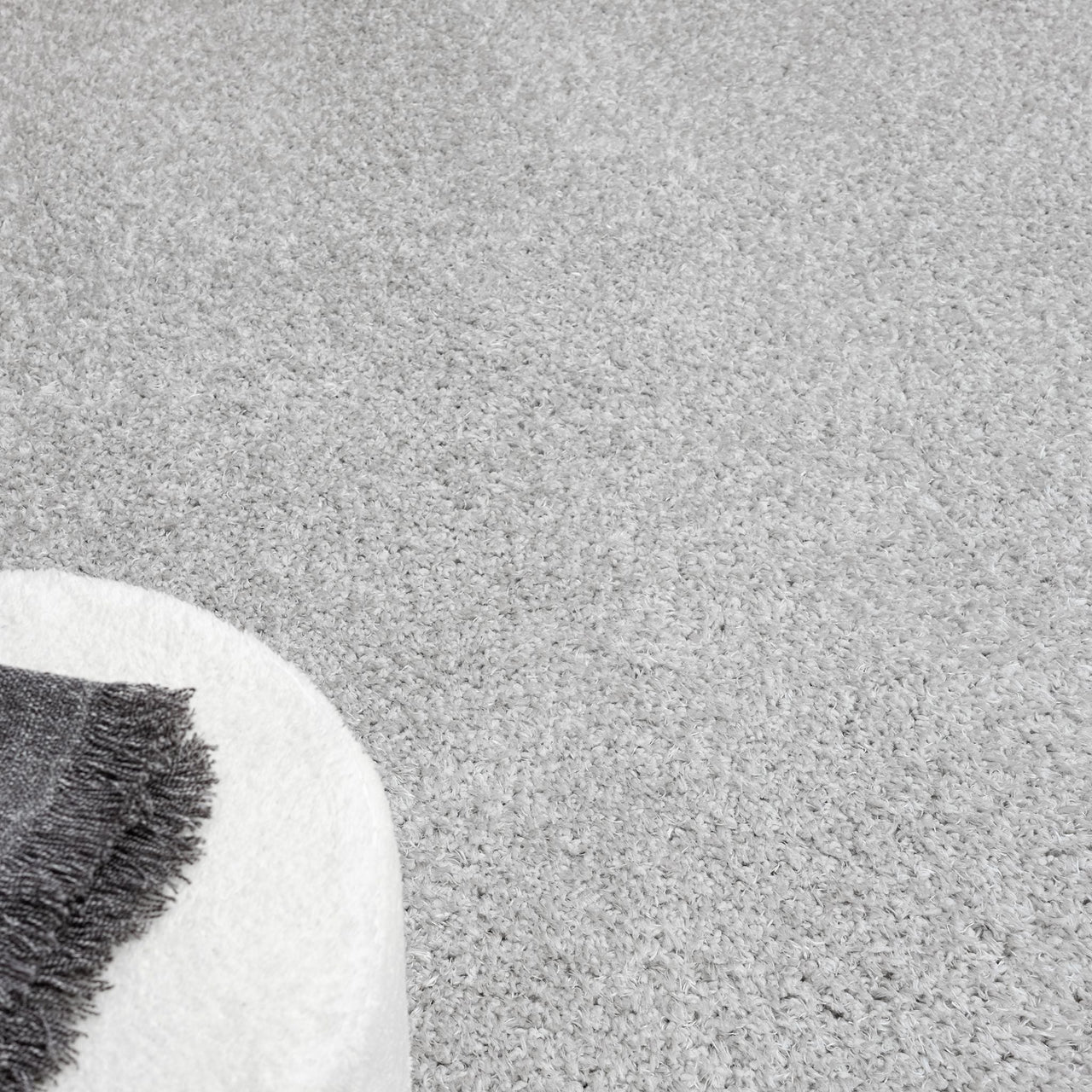 Grey modern shaggy rug with soft, textured polyester fibers and a plush pile.
