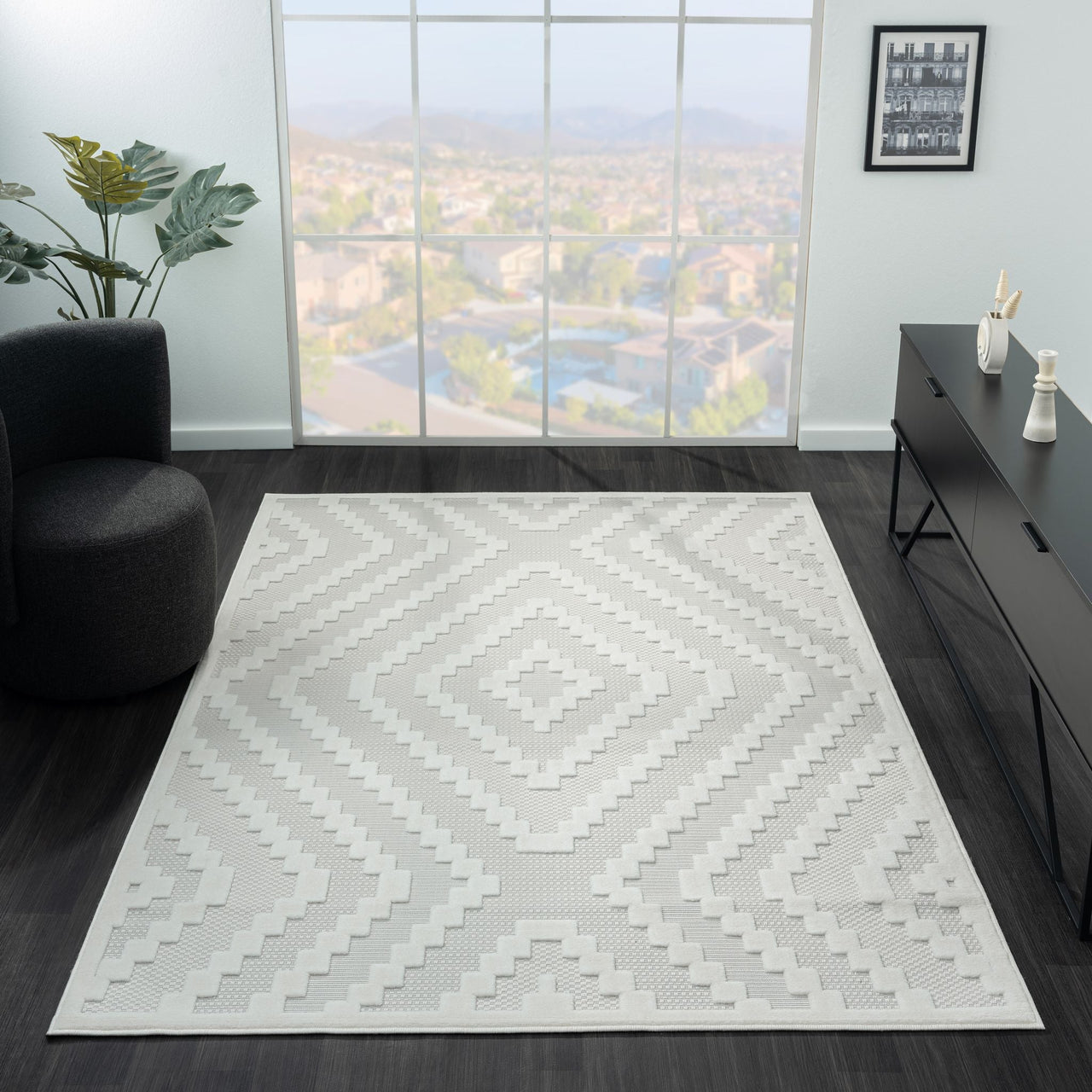 Cream geometric patterned modern rug with textured, light-neutral design on dark floor.