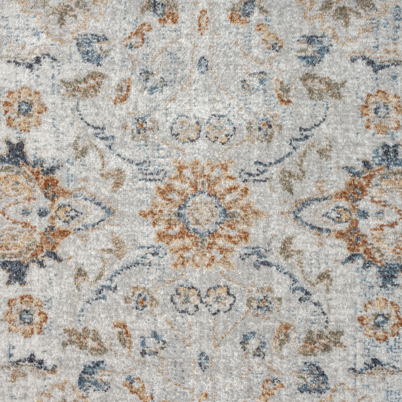 Multi-colored transitional rug with intricate floral and medallion pattern in blue, beige, and rust tones on a light.