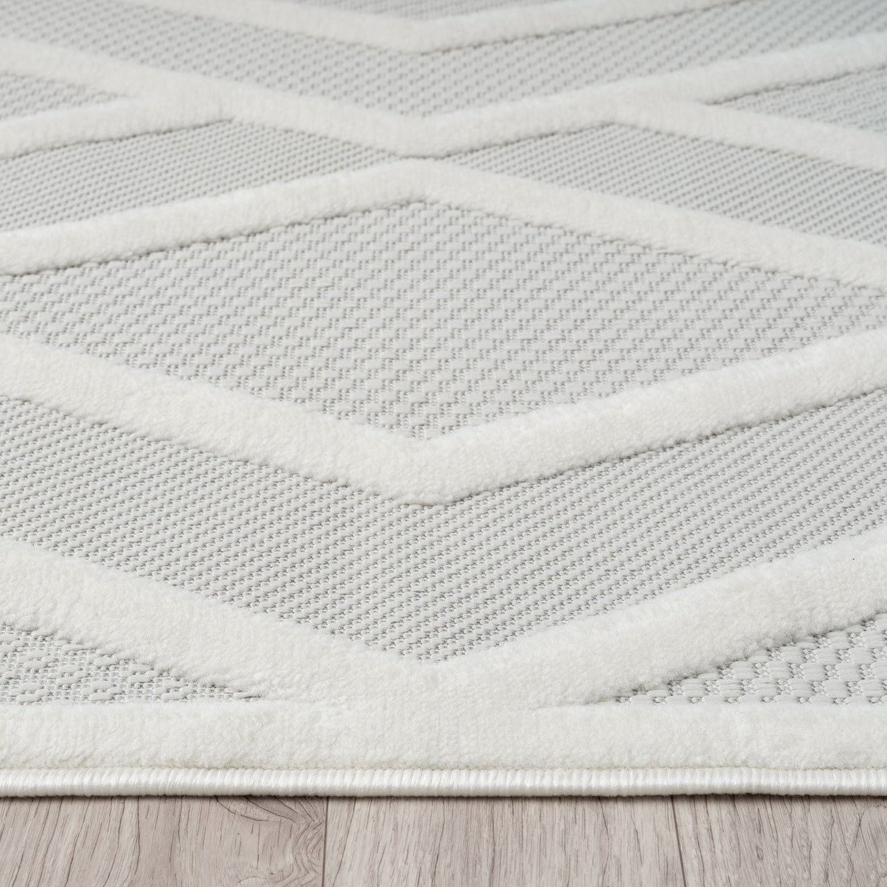 Grey and white modern rug with textured geometric pattern and polypropylene pile.