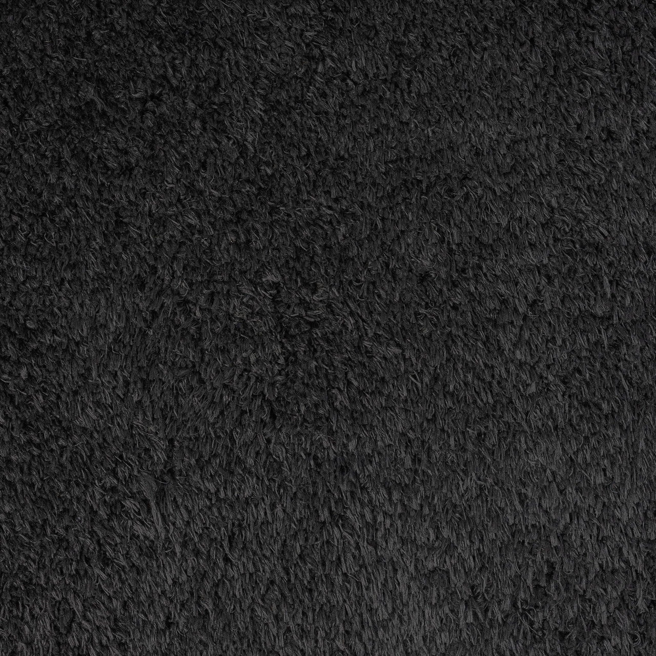 Black modern shaggy runner rug with dense plush polyester fibers and soft texture.