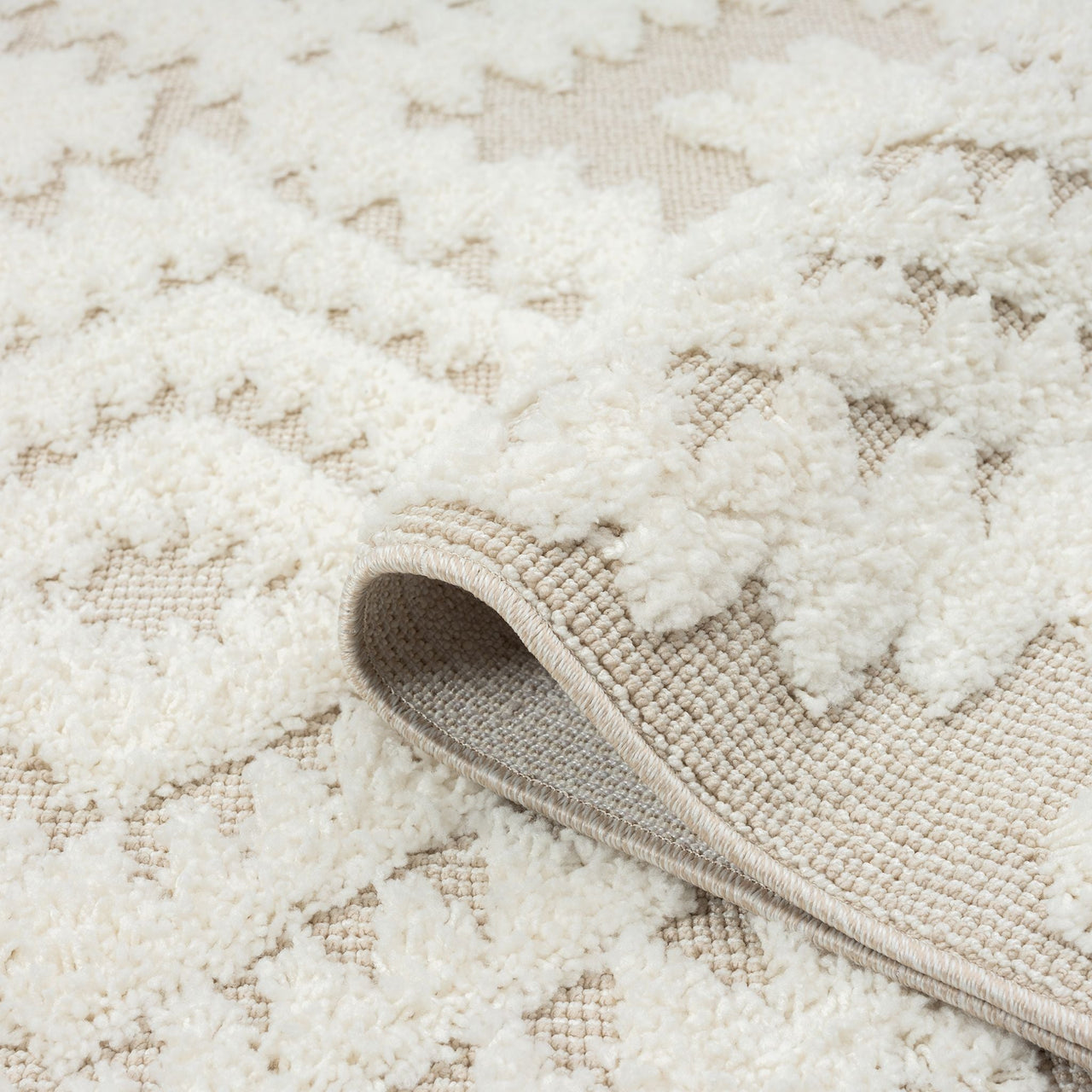 Beige and white runner rug with textured modern geometric patterns and fringed edges.